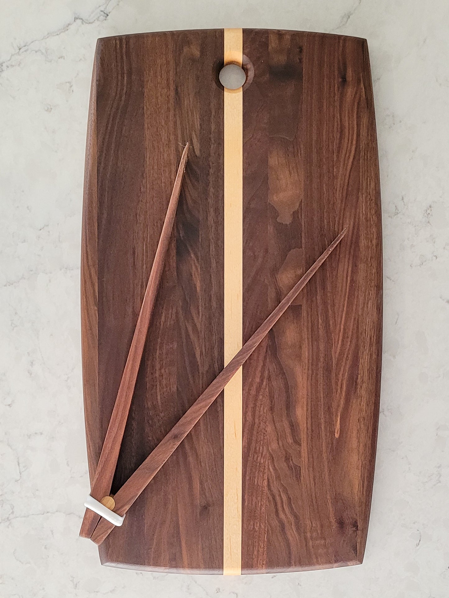 Walnut and maple strip cutting board with curved edges