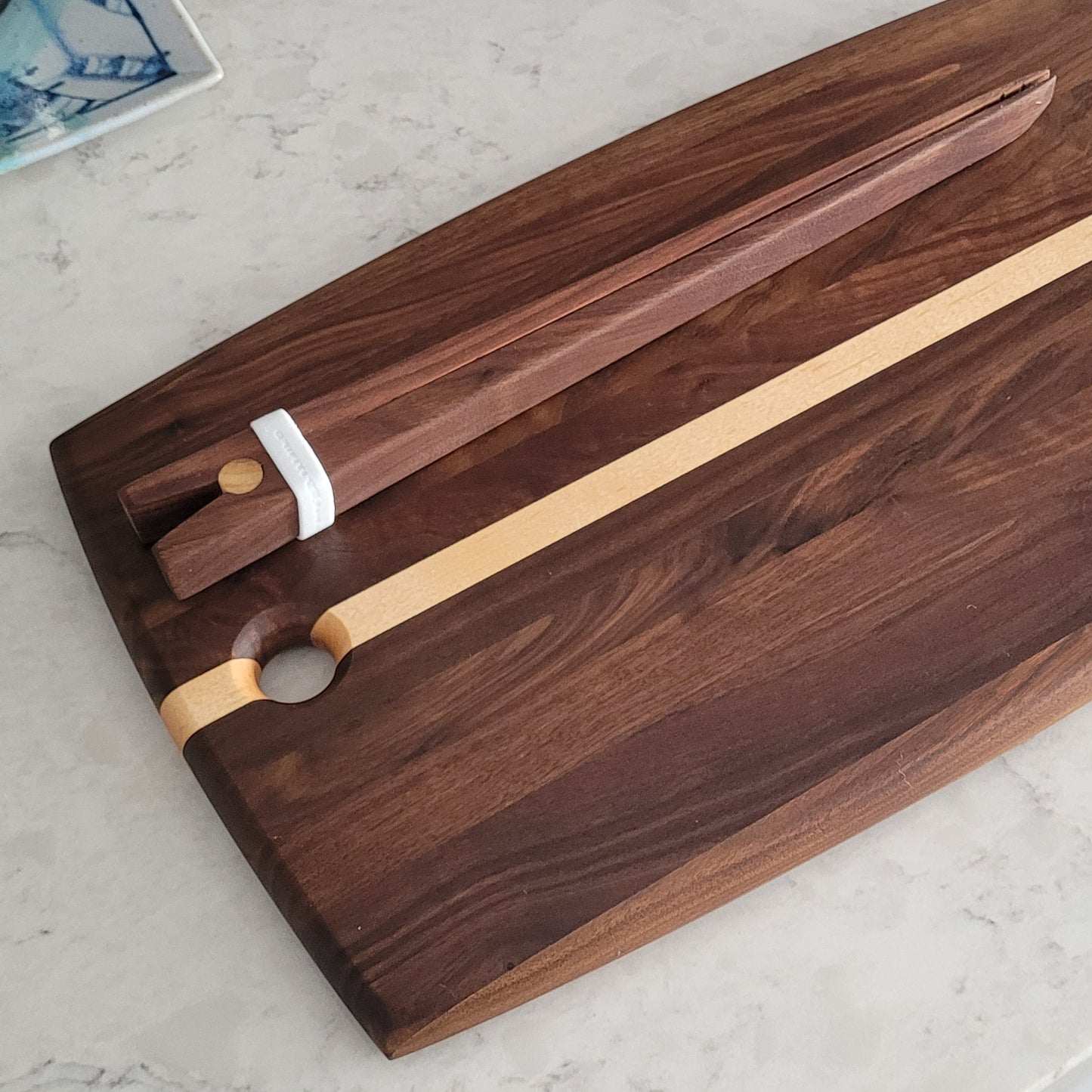 Walnut and maple strip cutting board with curved edges