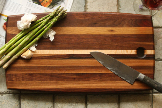 Walnut and maple strip cutting board with curved edges