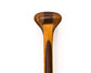 a beavertail canoe paddle that has a light colored blade and a dark inlay for the grip and shaft. made with BC fir and walnut and cherry hardwood. the picture shows a detail of the grip and blade