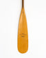 a beavertail canoe paddle that has a light colored blade and a light inlay for the grip and shaft. made with BC fir and walnut and cherry hardwood. the picture shows a detail of the grip and blade