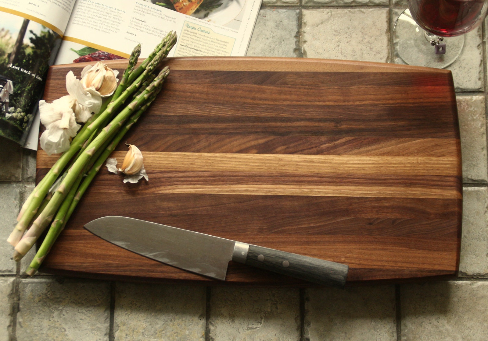 Walnut cutting board or serving tray with curved edges.