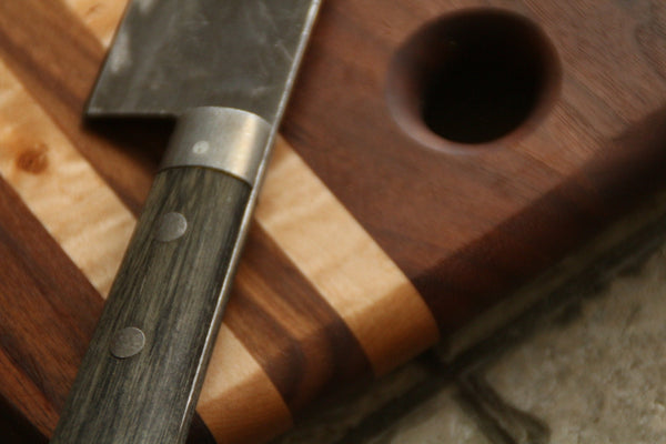 Walnut cutting board or serving tray with curved edges.